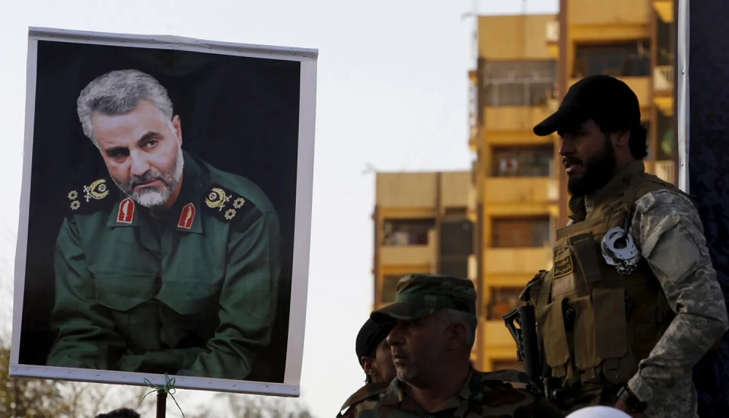 Members from Iraq’s Popular Mobilization Units hold a portrait of Iranian commander Major General Qassem Soleimani during a demonstration in Baghdad March 31, 2015. (Reuters)