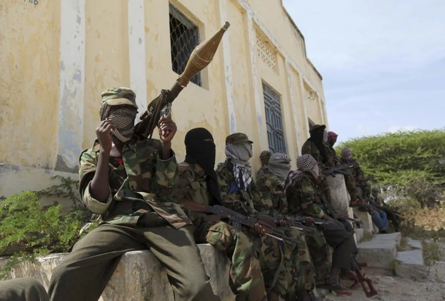 Al Shabaab soldiers sit outside a building during patrol along the streets of Dayniile district in Southern Mogadishu, March 5, 2012. REUTERS/Feisal Omar