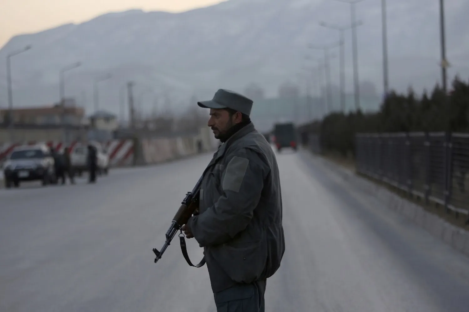 A member of the Afghan security forces stands guard near the site of two blasts Afghanistan in 2010. (AP)