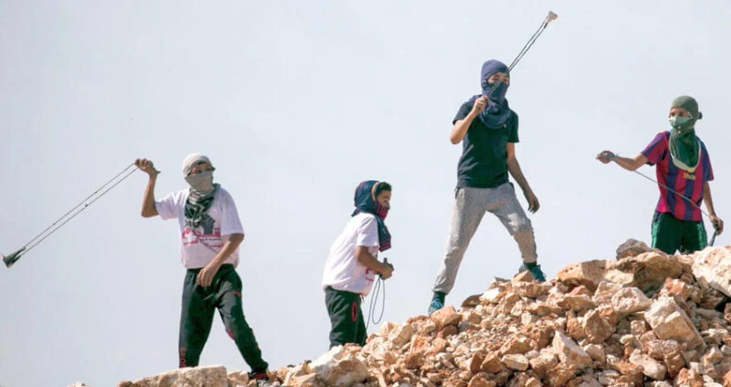 خلال مواجهات بين فلسطينيين وجنود الاحتلال الإسرائيلي قرب نابلس في الضفة الغربية أمس (أ.ف.ب)
