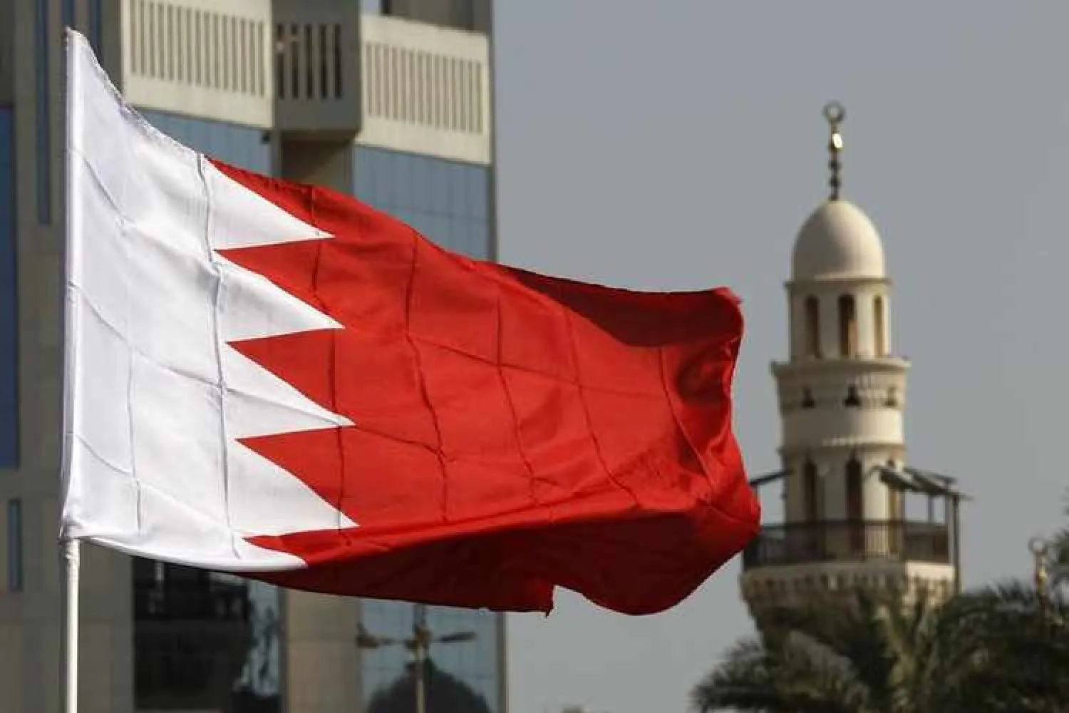 A Bahraini flag raised by protesters flutters in front of a local mosque during an anti-government demonstration. REUTERS/Hamad I Mohammed
