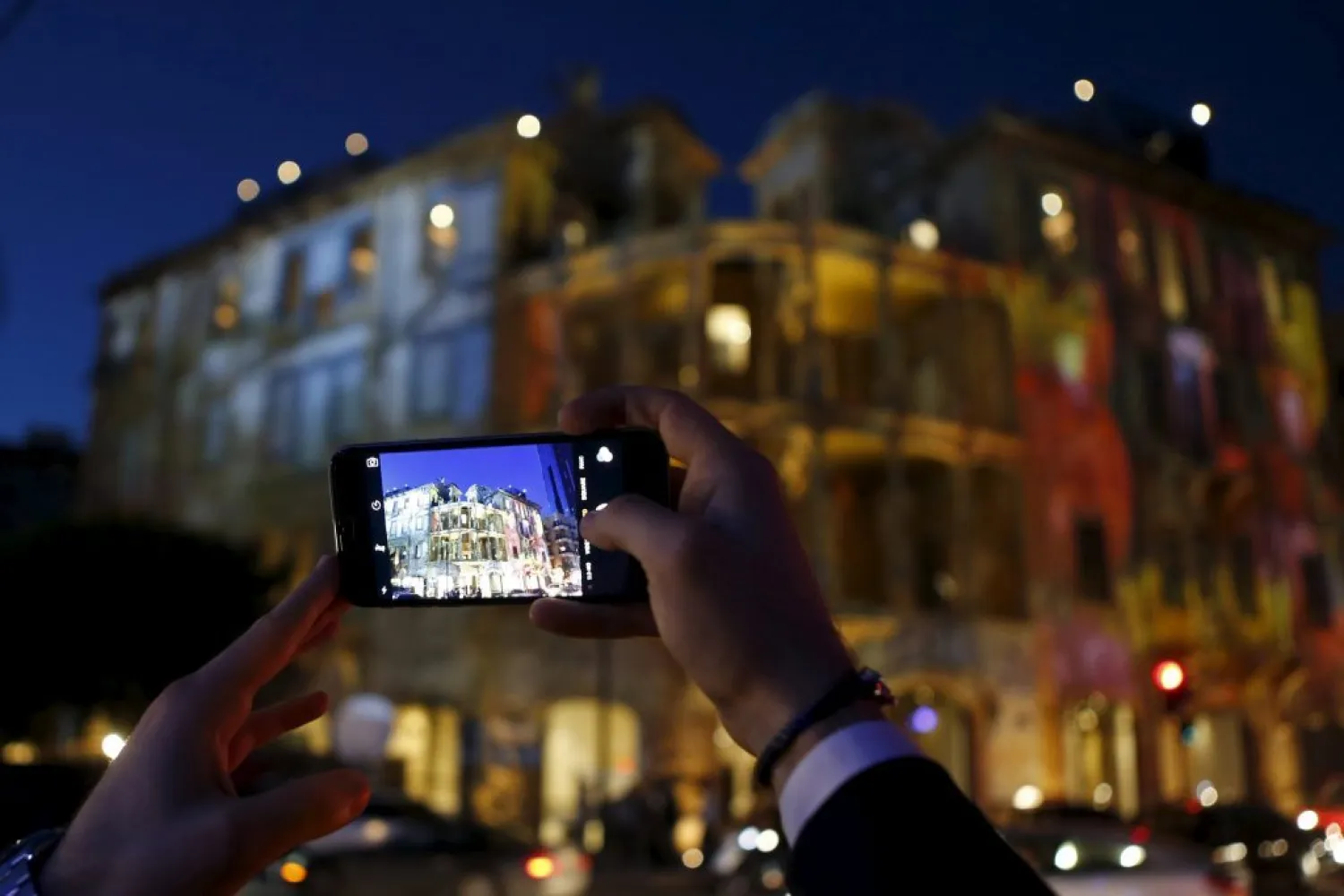 File photo: A man takes a picture of the historic Beit Beirut building, during a ceremony marking the end of its restoration in Beirut. (Mohamed Azakir / REUTERS) 
