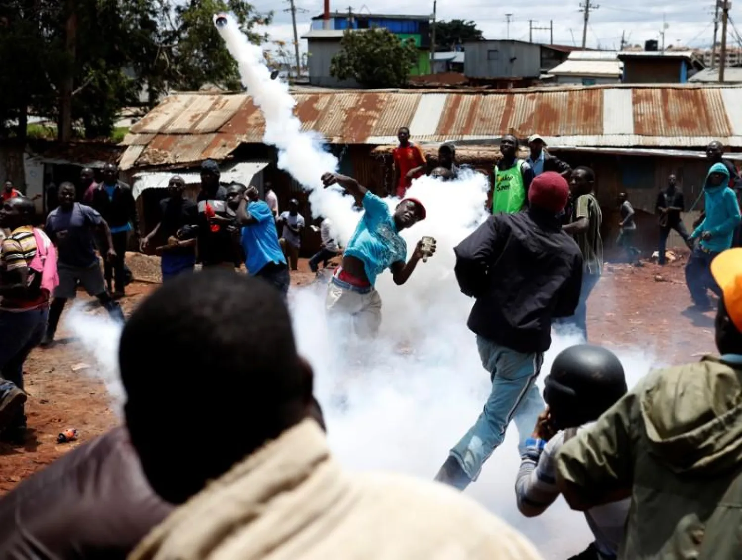 An opposition supporter returns a teargas canister fired by police during clashes in Kibera slum in Nairobi, Kenya October 26, 2017. REUTERS/Goran Tomasevic
