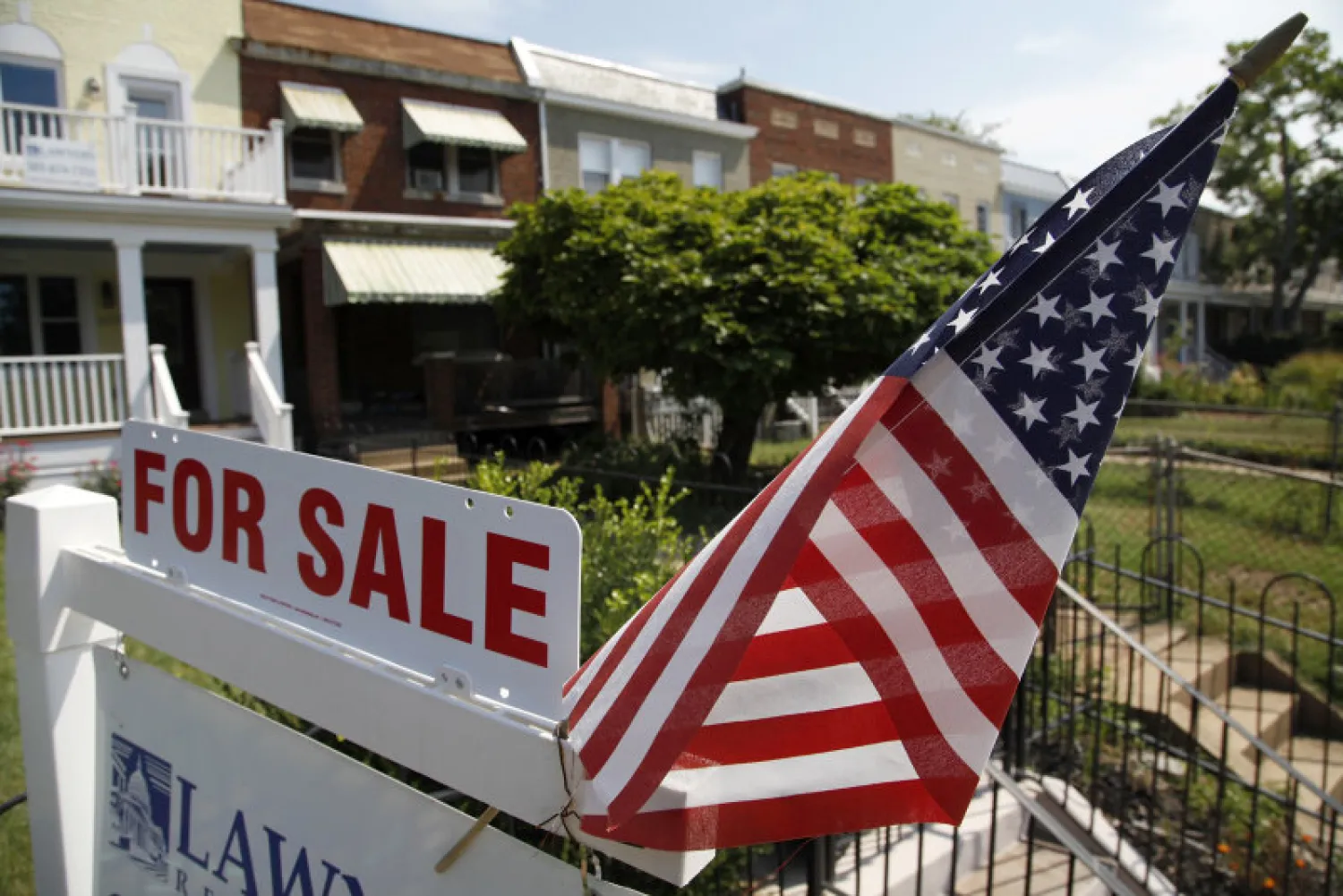 A US flag decorates a for-sale sign at a home in the Capitol Hill neighborhood of Washington, August 21, 2012. REUTERS/Jonathan Ernst