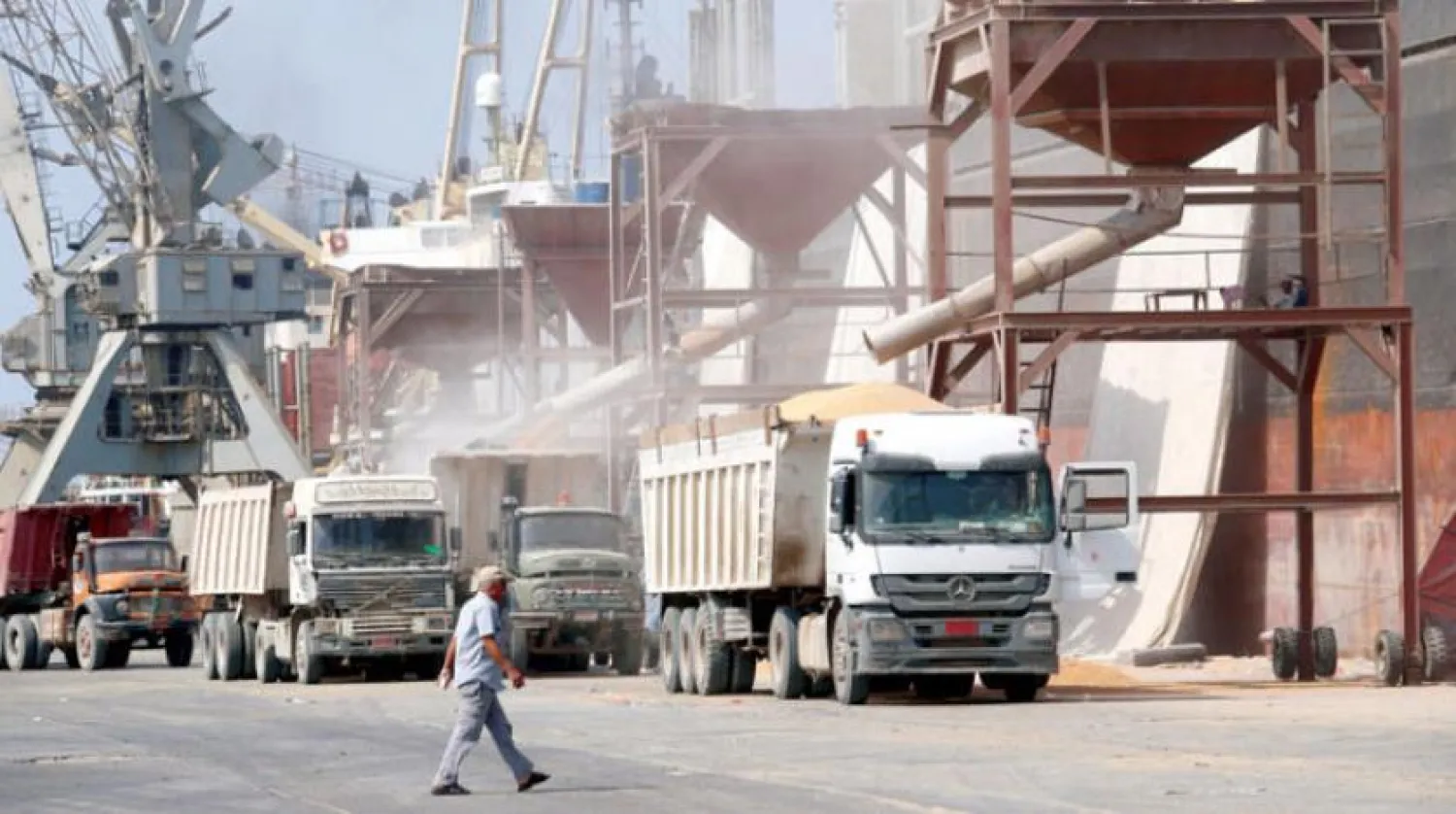 Yemeni walks by loading trucks near Port Hodeidah, west Yemen. Reuters