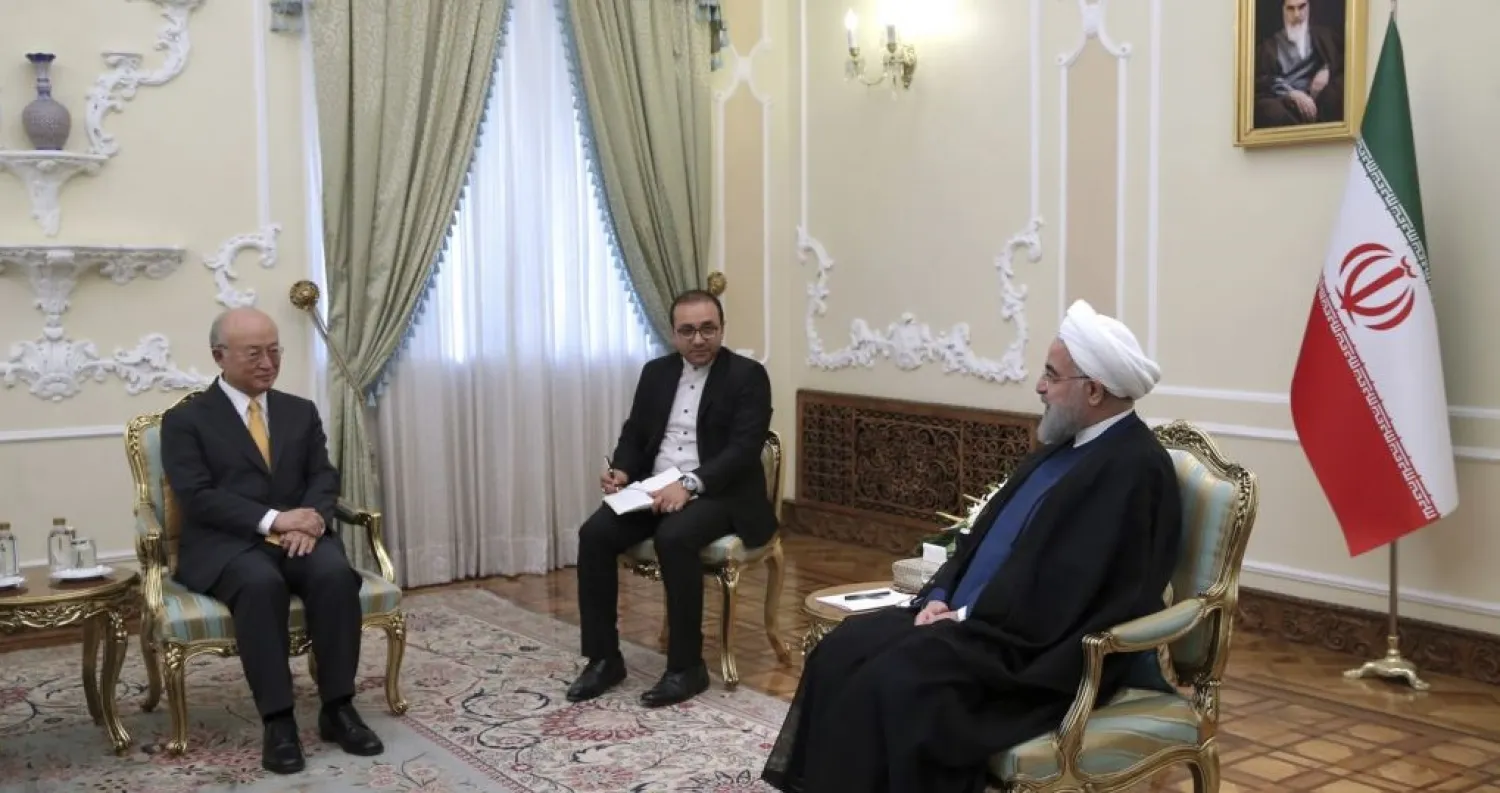 In this photo released by the office of the Iranian Presidency, President Hassan Rouhani, right, speaks with Director General of the International Atomic Energy Agency, IAEA, Yukiya Amano, left, during their meeting, in Tehran, Iran, Oct. 29, 2017. AP