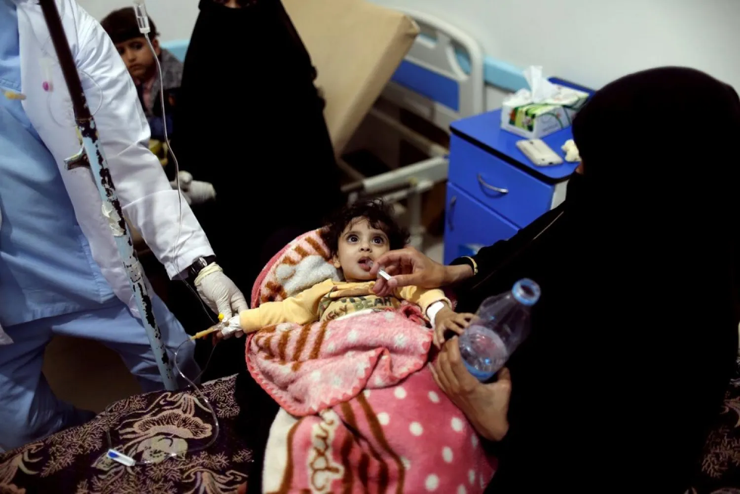 A woman gives her daughter re-hydration fluid at a cholera treatment center in Sana’a, Yemen. (Reuters)