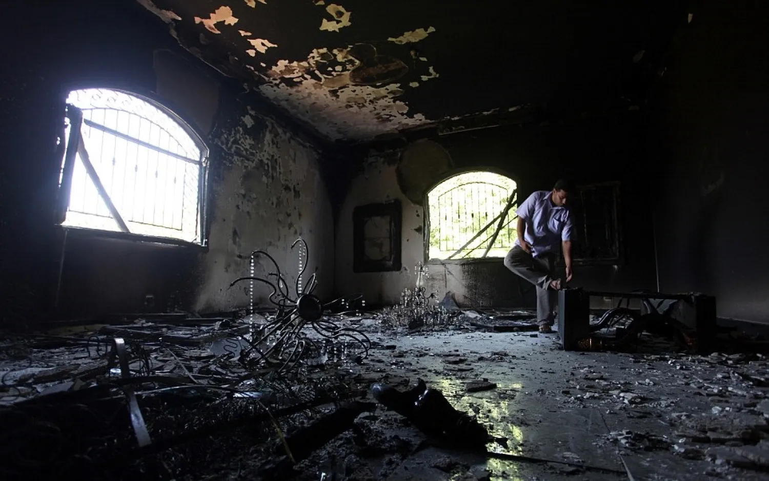 A Libyan man investigates the inside of the US Consulate in Benghazi following the attack. AP file photo