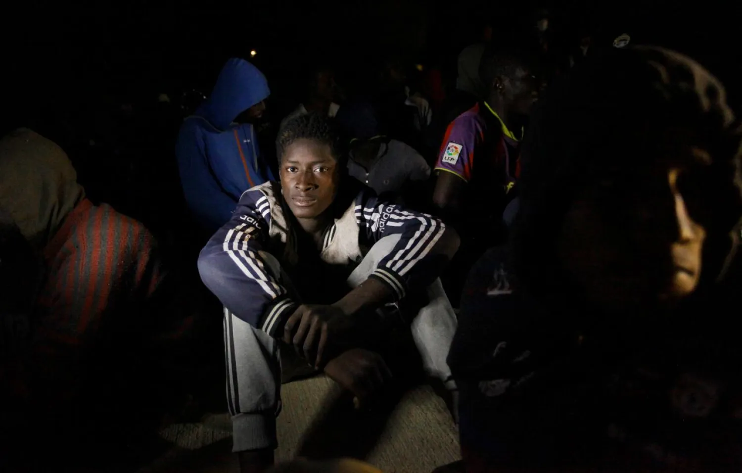 Migrants sit at a naval base after they were rescued by Libyan coastguard, in Tripoli, Libya October 31, 2017. REUTERS/Ismail Zitouny