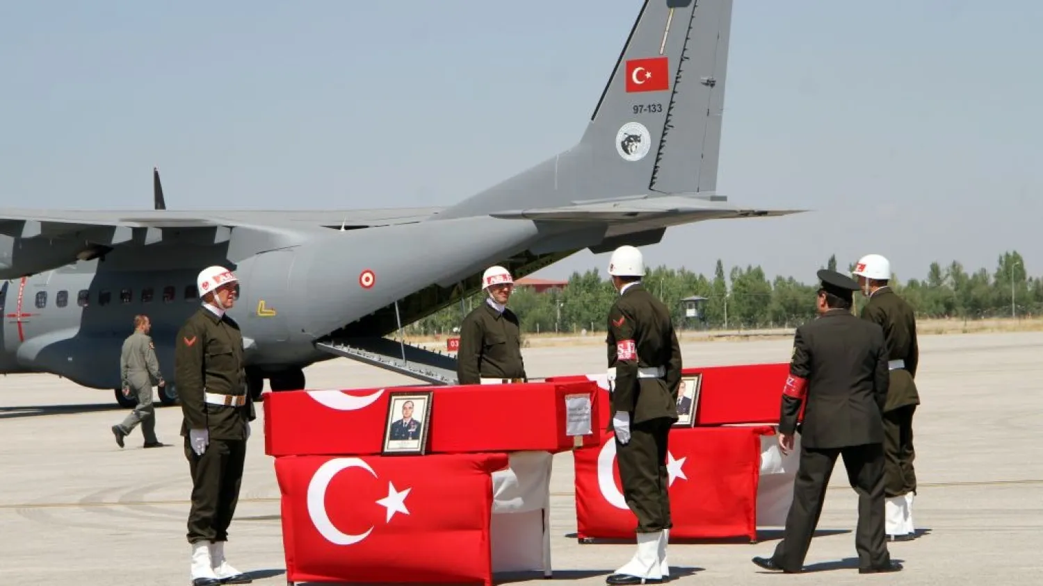 Turkish soldiers prepare the coffins of fallen comrades killed in a Kurdish rebel attack before a ceremony at the military airport in Van, Turkey, Sept. 8, 2015. AP photo