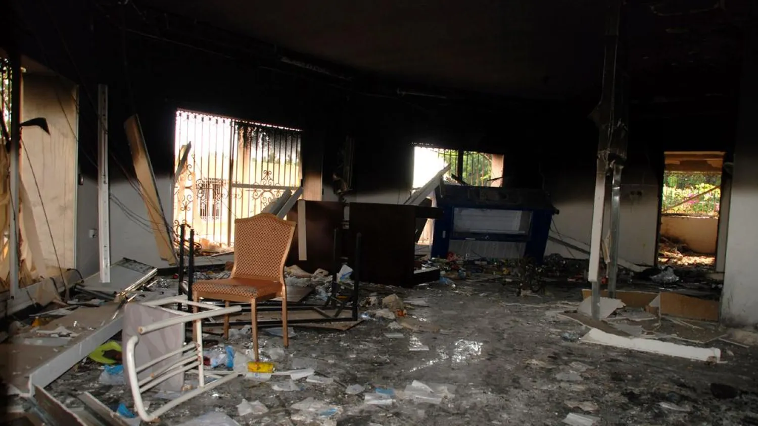 This Sept. 12, 2012 file photo shows glass, debris and overturned furniture are strewn inside a room in the gutted US consulate in Benghazi, Libya, after an attack that killed four Americans, including Ambassador Chris Stevens. (AP Photo/Ibrahim Alaguri, File) 
