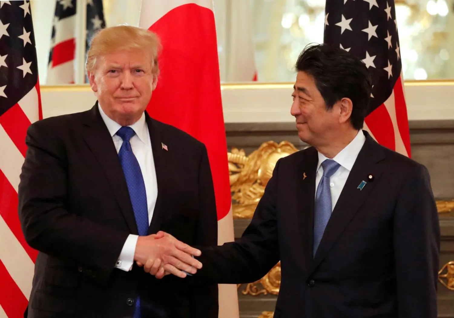 US President Donald Trump and Japan's Prime Minister Shinzo Abe shake hands before a working lunch at Akasaka Palace in Tokyo, Japan November 6, 2017. REUTERS/Jonathan Ernst