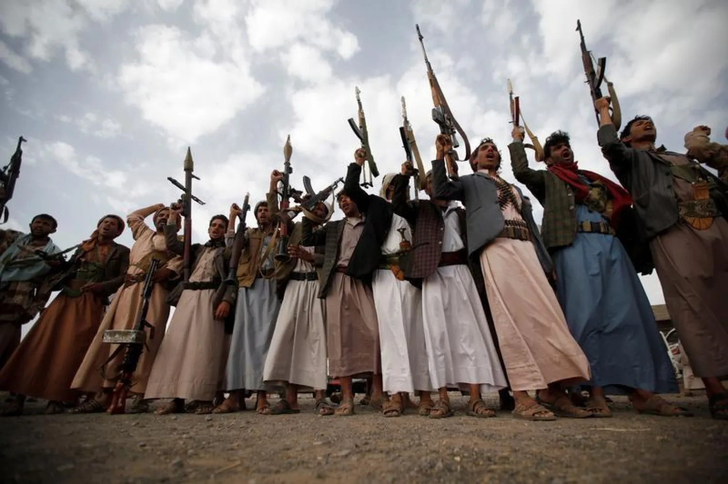 Houthi fighters hold up their weapons as they attend a tribal gathering in Sana’a, Yemen June 20, 2016. (Reuters)