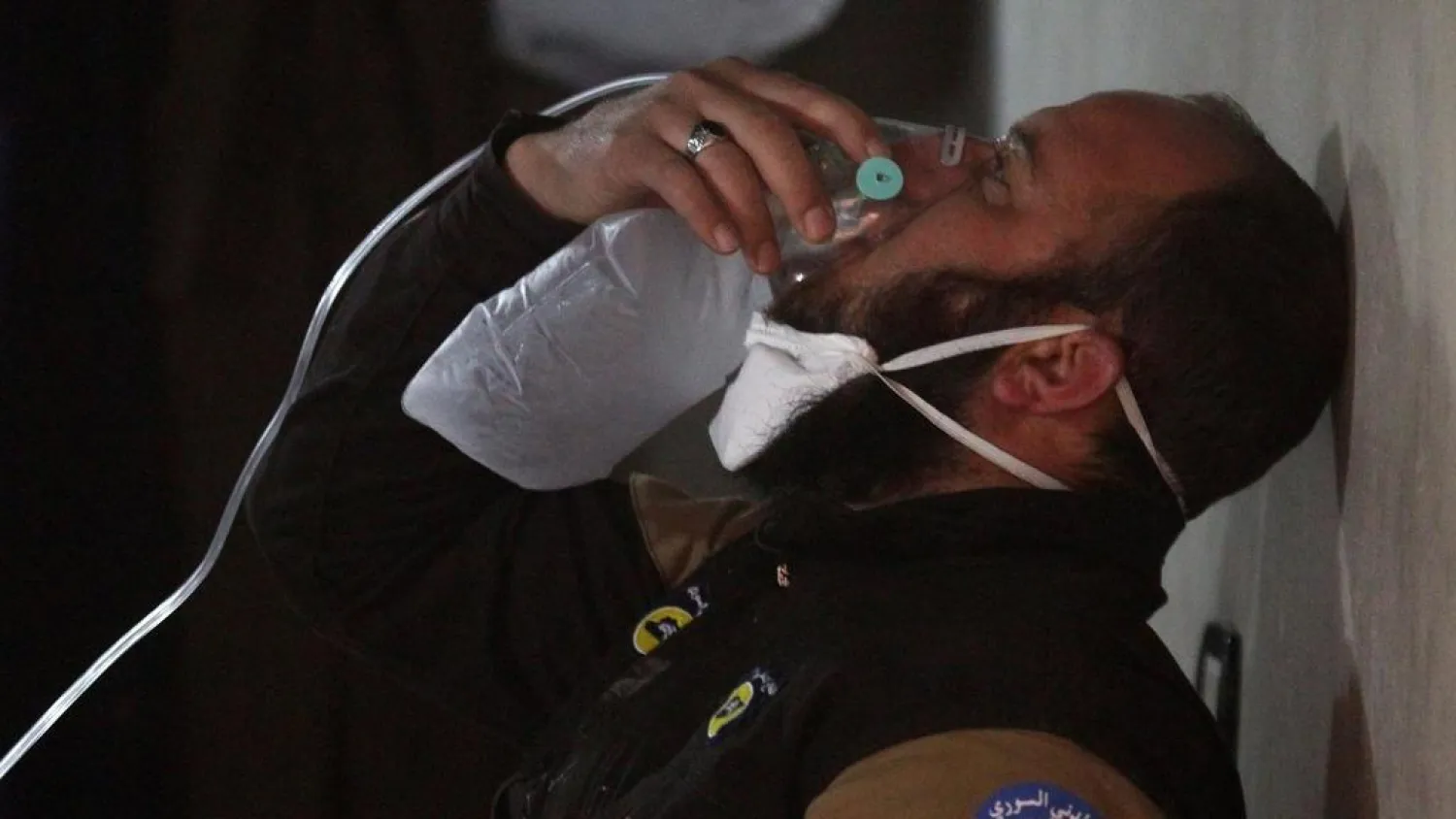 A Syrian civil defense member breathes through an oxygen mask, after a chemical attack on the town of Khan Sheikhoun, Idlib province, on April 4, 2017. (Reuters)