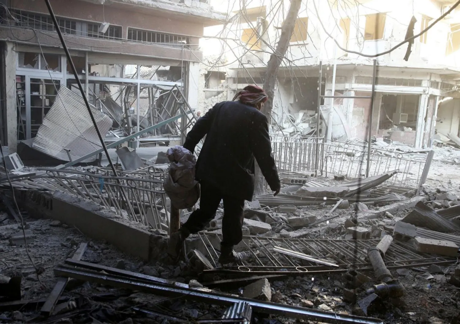 A man walks on rubble after an airstrike in the rebel-held city of Douma, in the eastern Damascus suburb of Ghouta Syria November 2, 2017. REUTERS/Bassam Khabieh