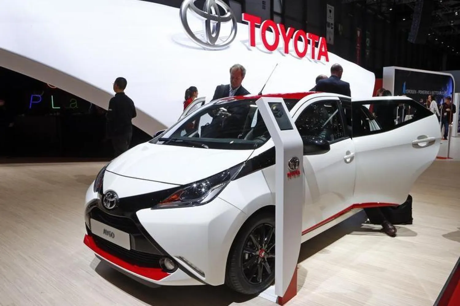 A man takes pictures of the interior of a Toyota Aygo during media day, ahead of the 84th Geneva Motor Show, at the Palexpo Arena in Geneva March 4, 2014. TREUTERS/Arnd Wiegmann 