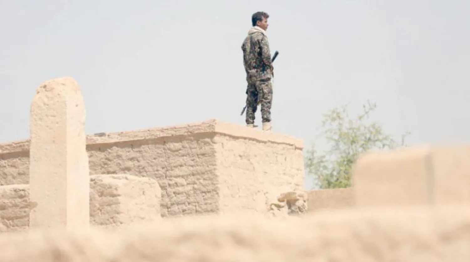 Yemeni pro-government soldier standing on top of a historical building in Marib. PHOTO: Reuters 