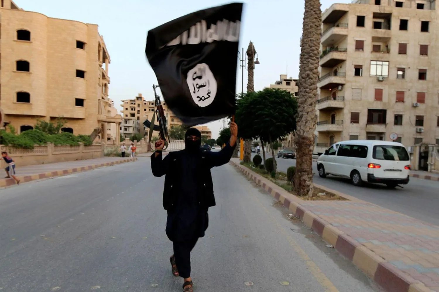 ISIS militant holding their flag. Reuters file photo.  
