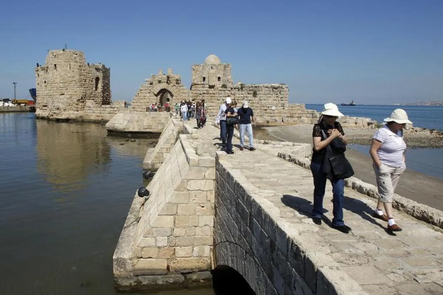 Tourists walk at the sea castle of the port-city of Sidon, southern Lebanon. Picture taken October 3, 2011. REUTERS/ Ali Hashisho (Reuters/ Ali Hashisho)