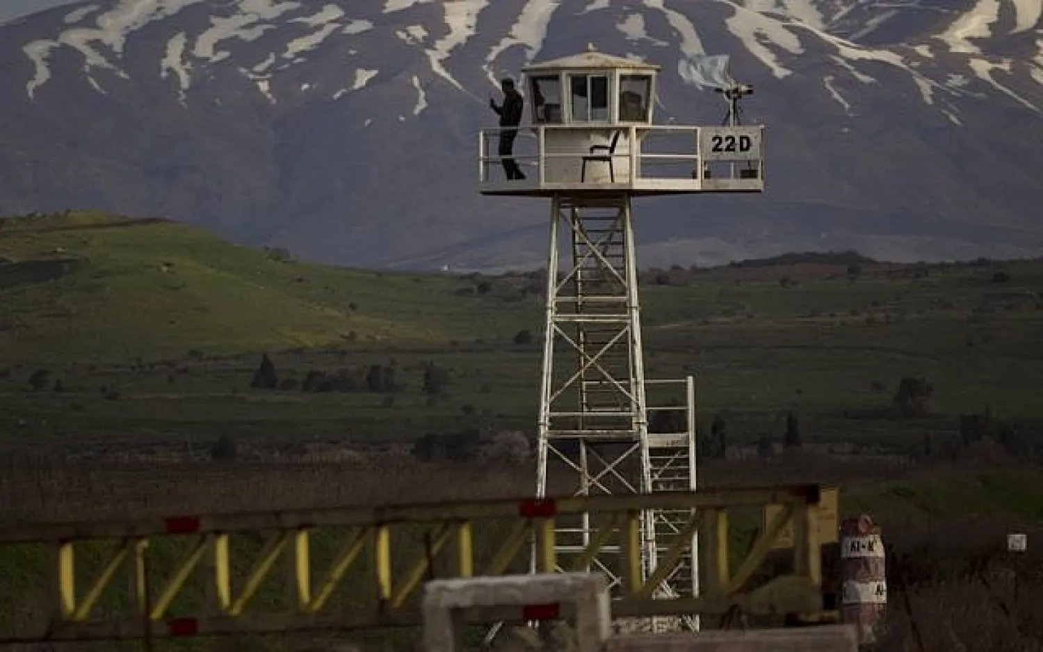 A UN peacekeeper from the UNDOF force stands guard on a watch tower at the Quneitra Crossing between the Syrian and Israeli sides of the Golan Heights, on Friday, March 8, 2013. (AP/Ariel Schalit)