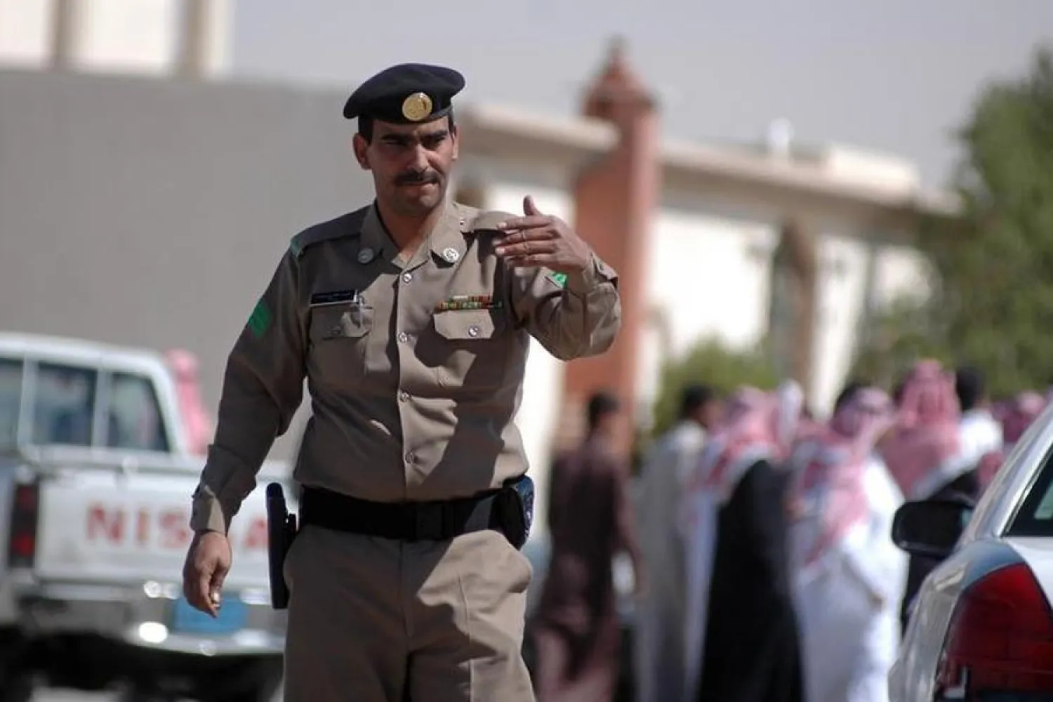A Saudi policeman directs traffic at a roadblock in the Yarmuk area of eastern Riyadh, Saudi Arabia . REUTERS/Sultan Fahad