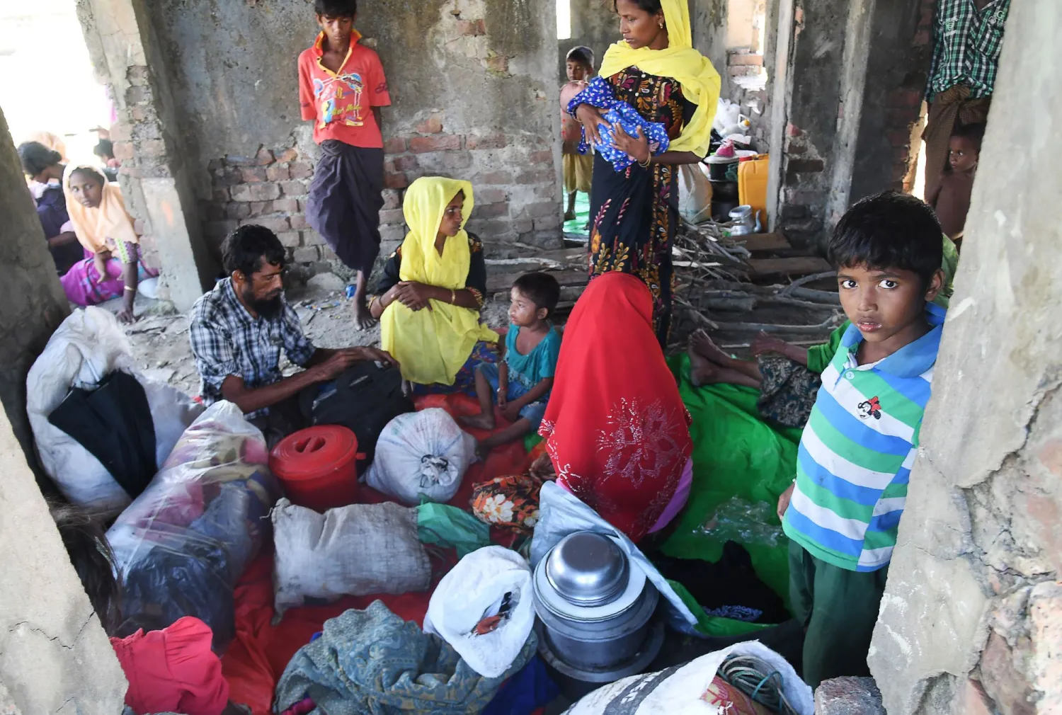 Rohingya Muslim refugees who entered Bangladesh by makeshift boats rest after walking toward refugee camps at Sabrang in the Teknaf district of Bangladesh. AFP