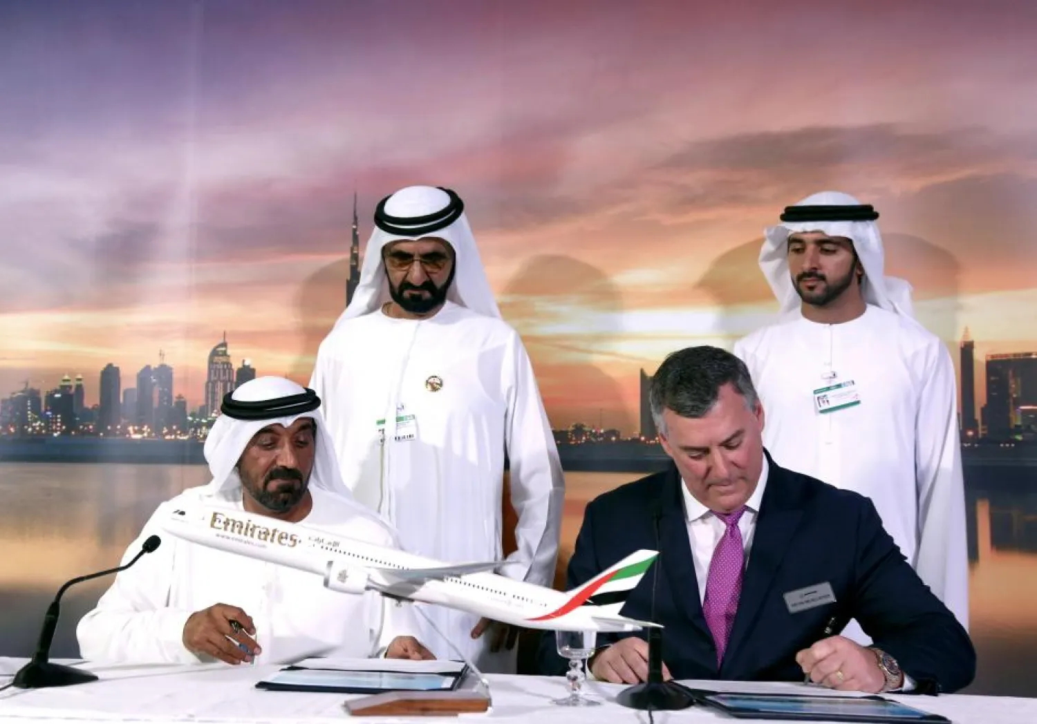 Sheikh Ahmed bin Saeed Al Maktoum (L), CEO & Chairman of Emirates Airline, Kevin Mcallister (R), Executive VP & CEO of Commercial Airplanes Boeing, sign contract during the press conference at Dubai Air Show in Dubai, UAE November 12, 2017. REUTERS/Satish Kumar
