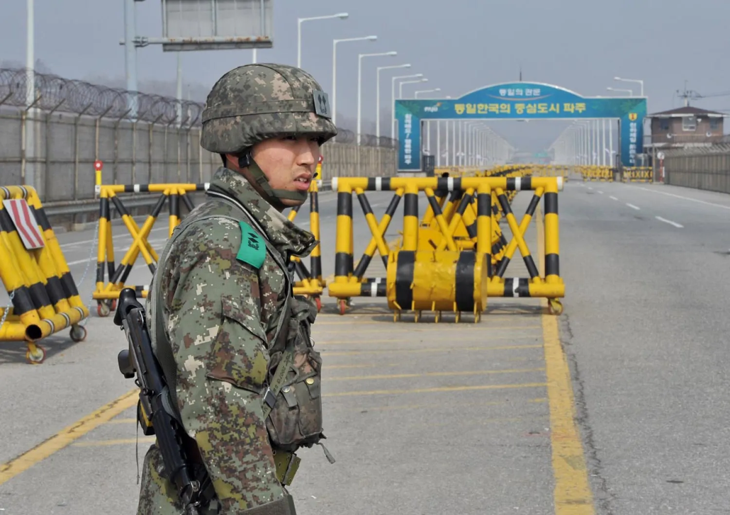 A South Korean soldier stands on a road linked to North Korea at a military checkpoint in Paju near the demilitarized zone (DMZ) dividing the two Koreas on April 3, 2013. (Jung Yeon-Jejung/AFP/Getty Images) 