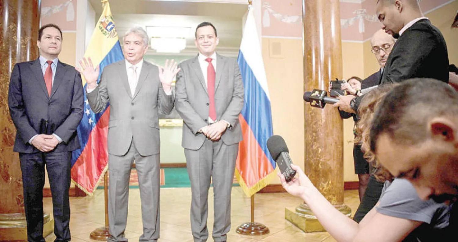 أعضاء الوفد الفنزويلي بعد توقيعه على اتفاق هيكلة دين من روسيا في مؤتمر صحافي بموسكو أمس (أ.ف.ب)