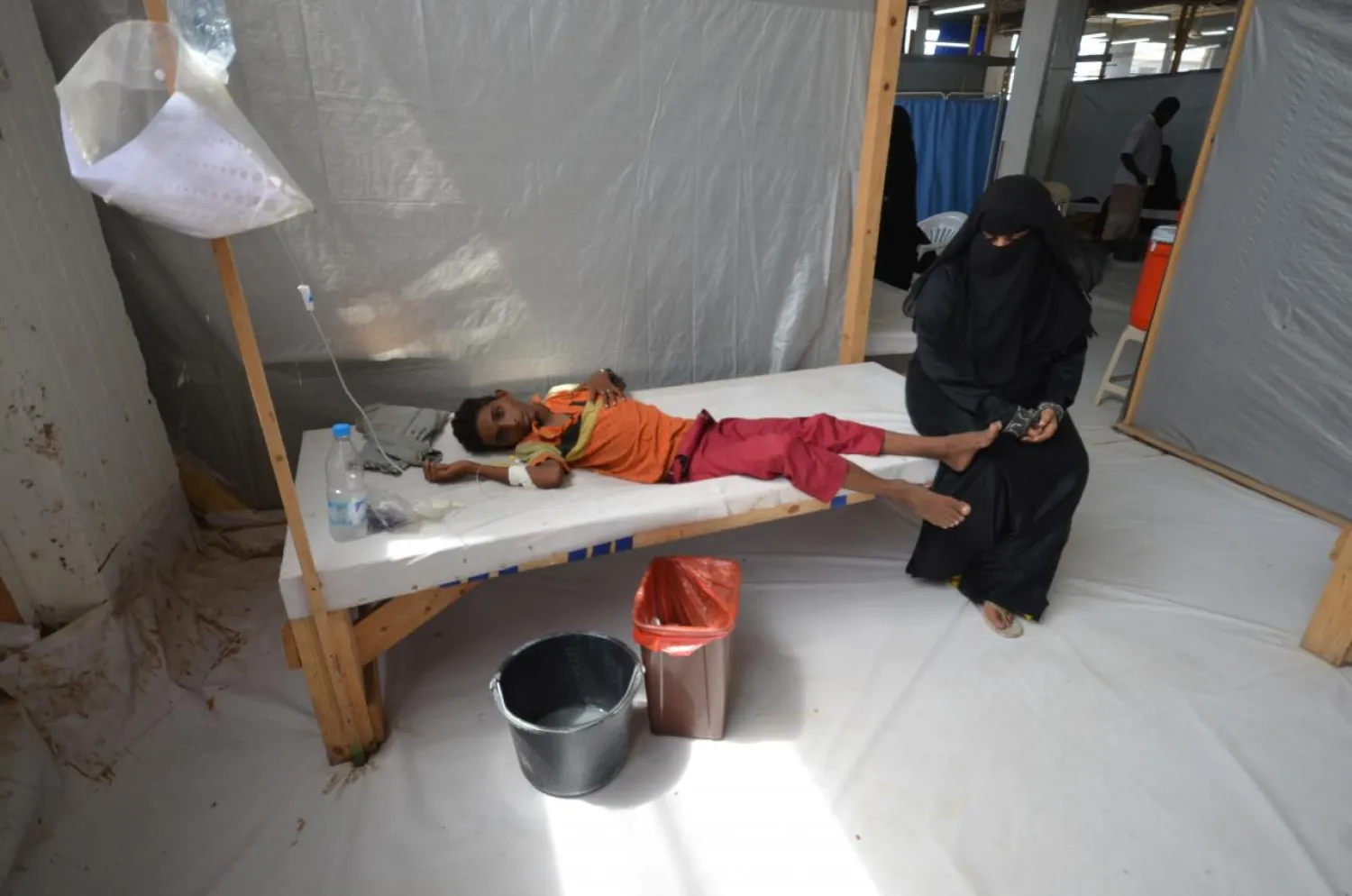 A woman sits next to her son, who is infected with cholera at a hospital in the Red Sea port city of Hodeidah. Reuters