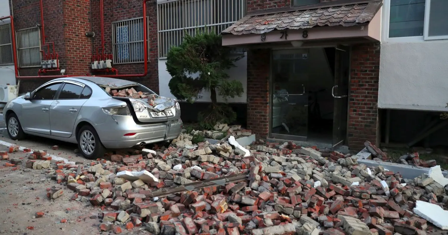 A car damaged by falling bricks after a 5.4-magnitude earthquake is seen in the southeastern port city of Pohang on November 15, 2017. YONHAP / AFP 