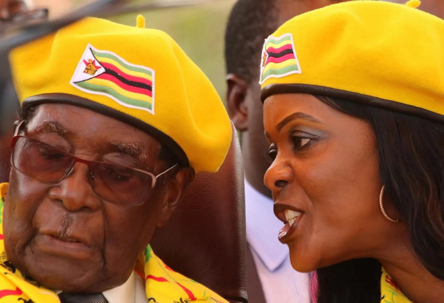 FILE PHOTO: President Robert Mugabe listens to his wife Grace Mugabe at a rally of his ruling ZANU(PF) party in Harare, Zimbabwe, November 8, 2017.REUTERS/Philimon Bulawayo/File Photo