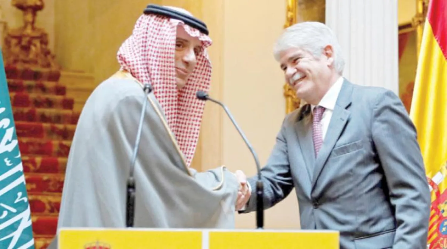 Saudi foreign minister shakes hands with Spanish counterpart after a meeting in Madrid, Friday. Asharq Al-Awsat Arabic.