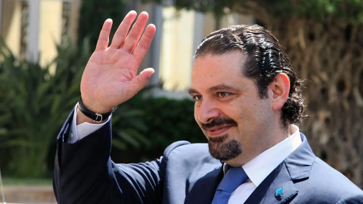 Saad Hariri waves upon his arrival at the government house in Beirut on Aug 8, 2014. Dalati and Nohra Photo