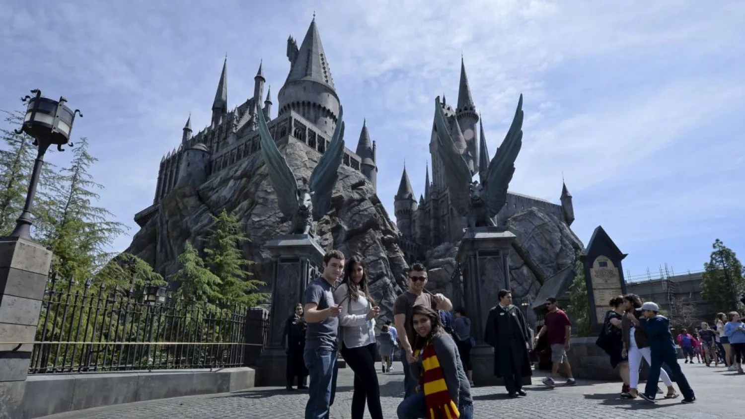Guests pose before they enter Hogwarts School during a soft opening and media tour of "The Wizarding World of Harry Potter" theme park at the Universal Studios Hollywood in Los Angeles, California March 22, 2016. Reuters