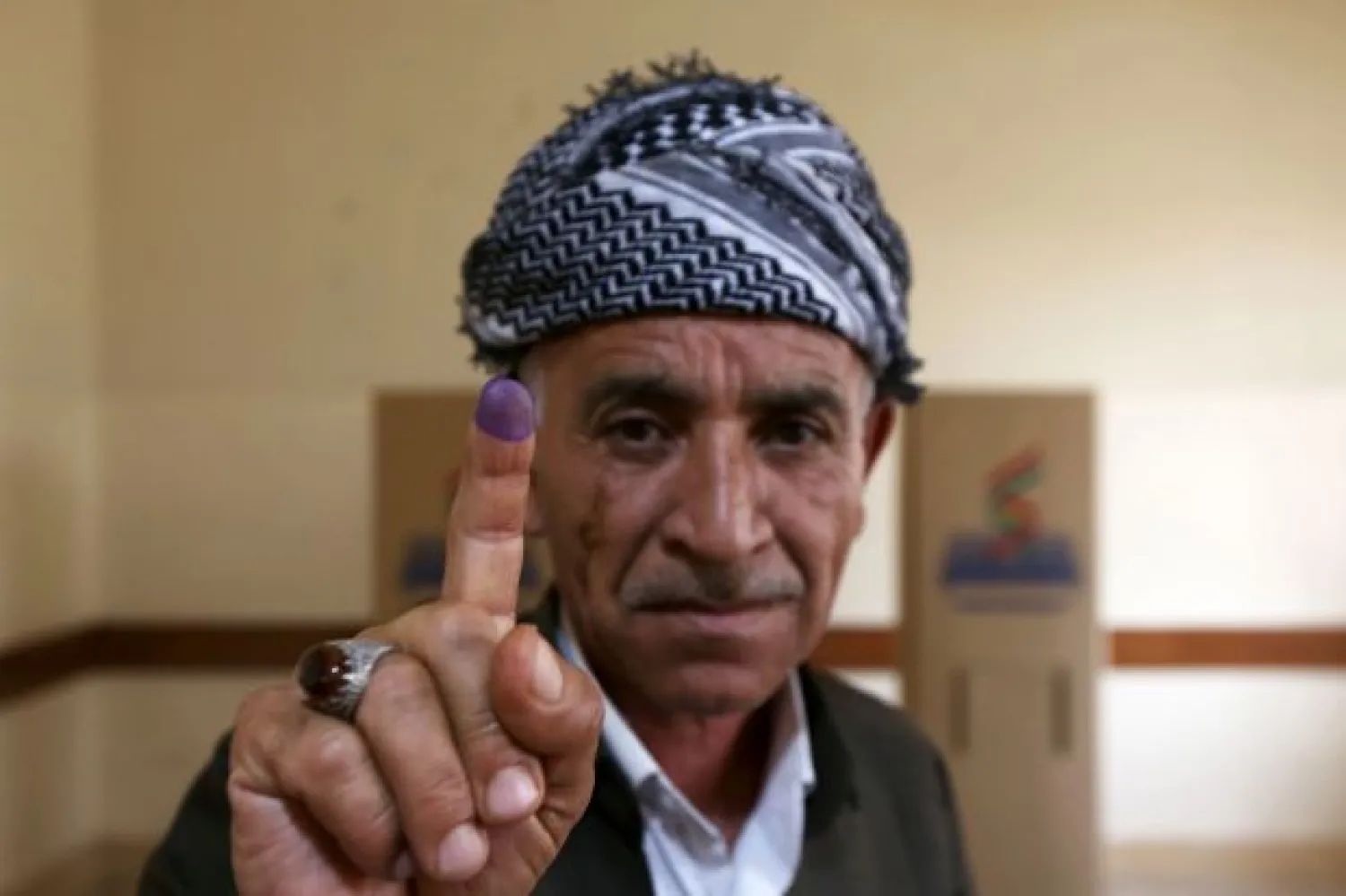 An Iraqi Kurdish man shows his ink-stained finger after voting in the Kurdish independence referendum in Erbil, the capital of the autonomous Kurdish region of northern Iraq, on September 25, 2017. AFP PHOTO