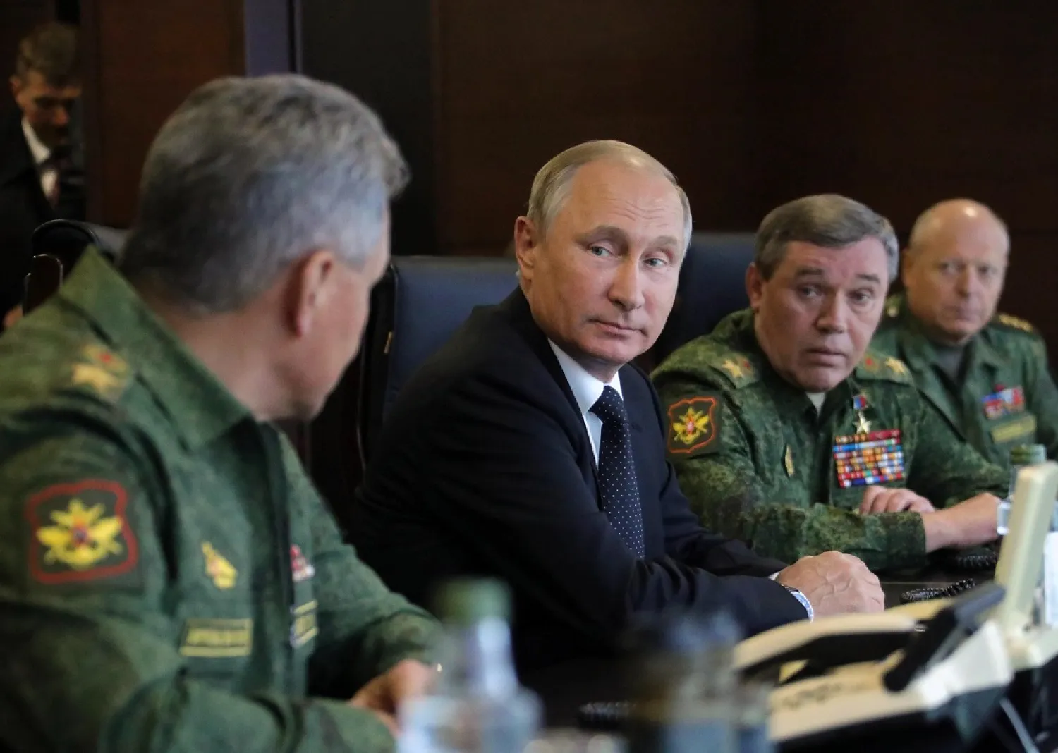 Russian President Vladimir Putin, center, speaks to Defense Minister Sergei Shoigu, left, as Chief of the General Staff of the Russian Armed Forces Valery Gerasimov, second right, looks on. (AP)