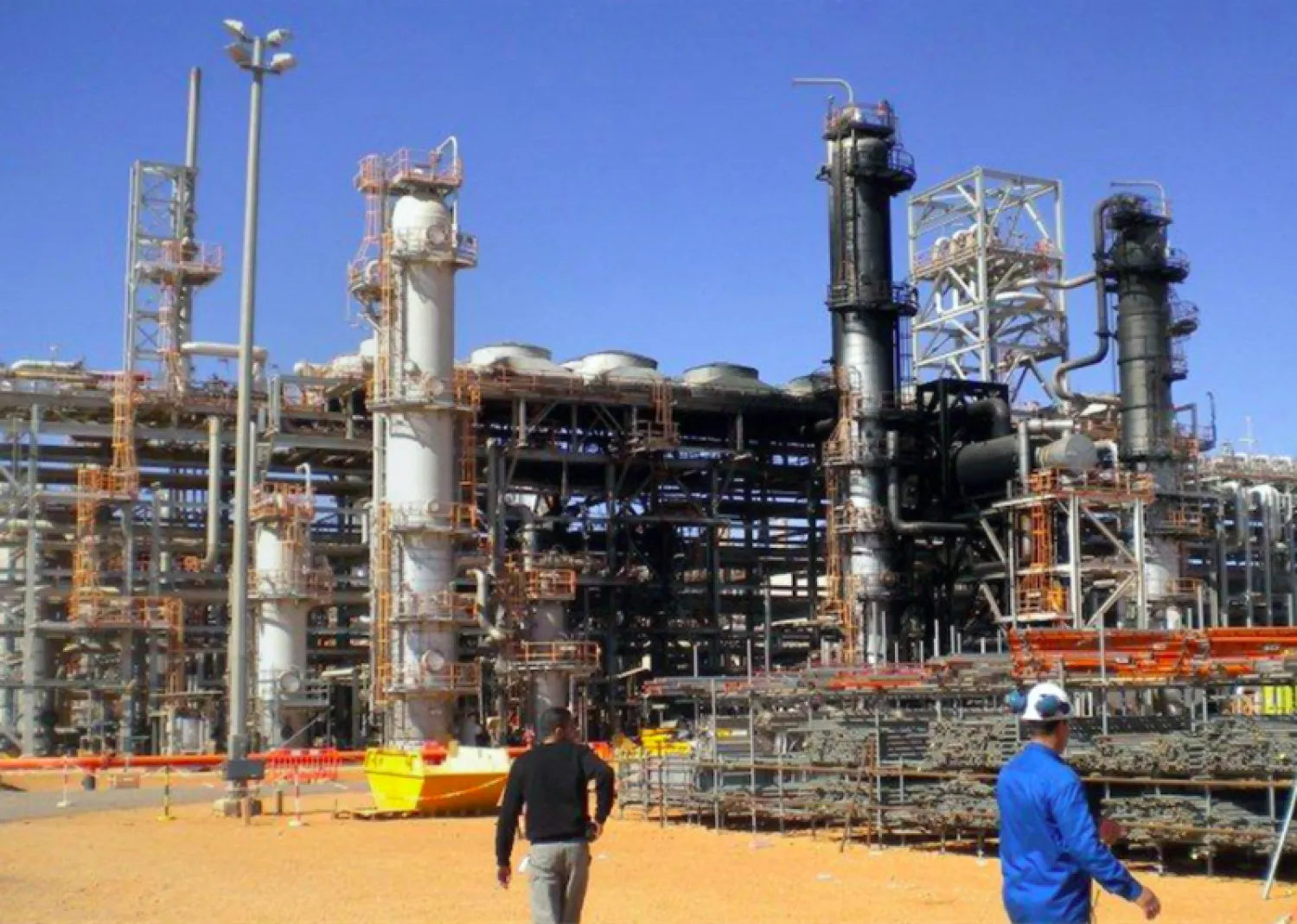 Workers outside a desert gas plant in Algeria. AFP file photo