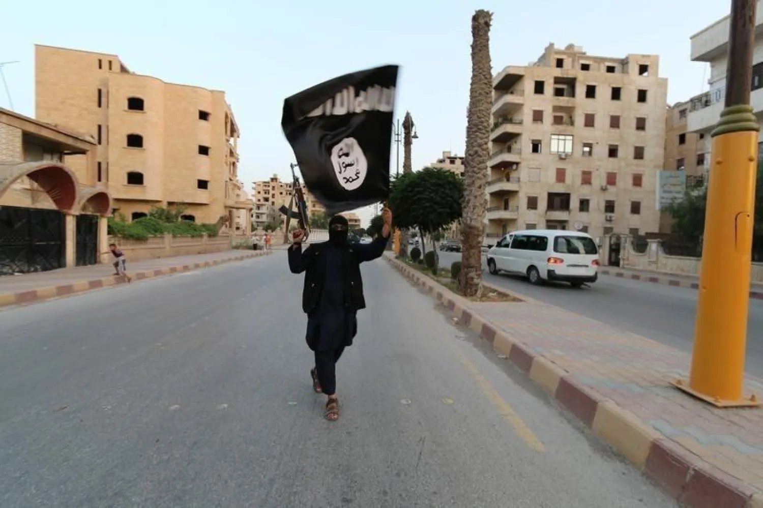 A member loyal to ISIS waves flag in Raqqa June 29, 2014. REUTERS/Stringer