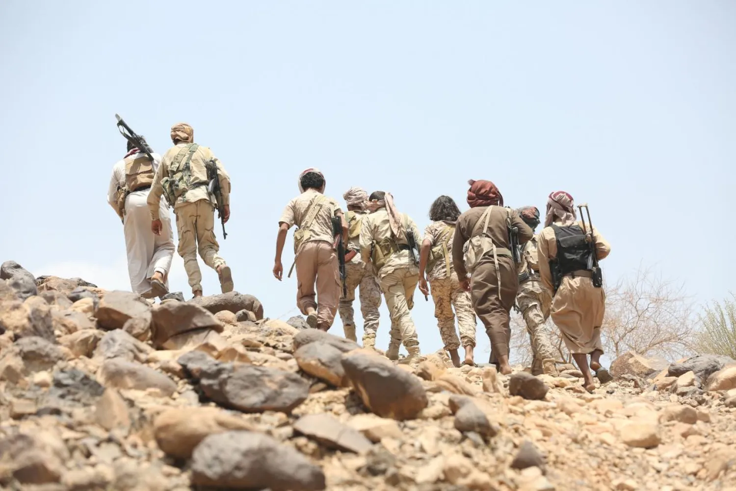 Soldiers and members of the Popular Resistance walk as they head to the frontline of fighting against Houthi militants in Makhdara area of Marib province. Reuters 