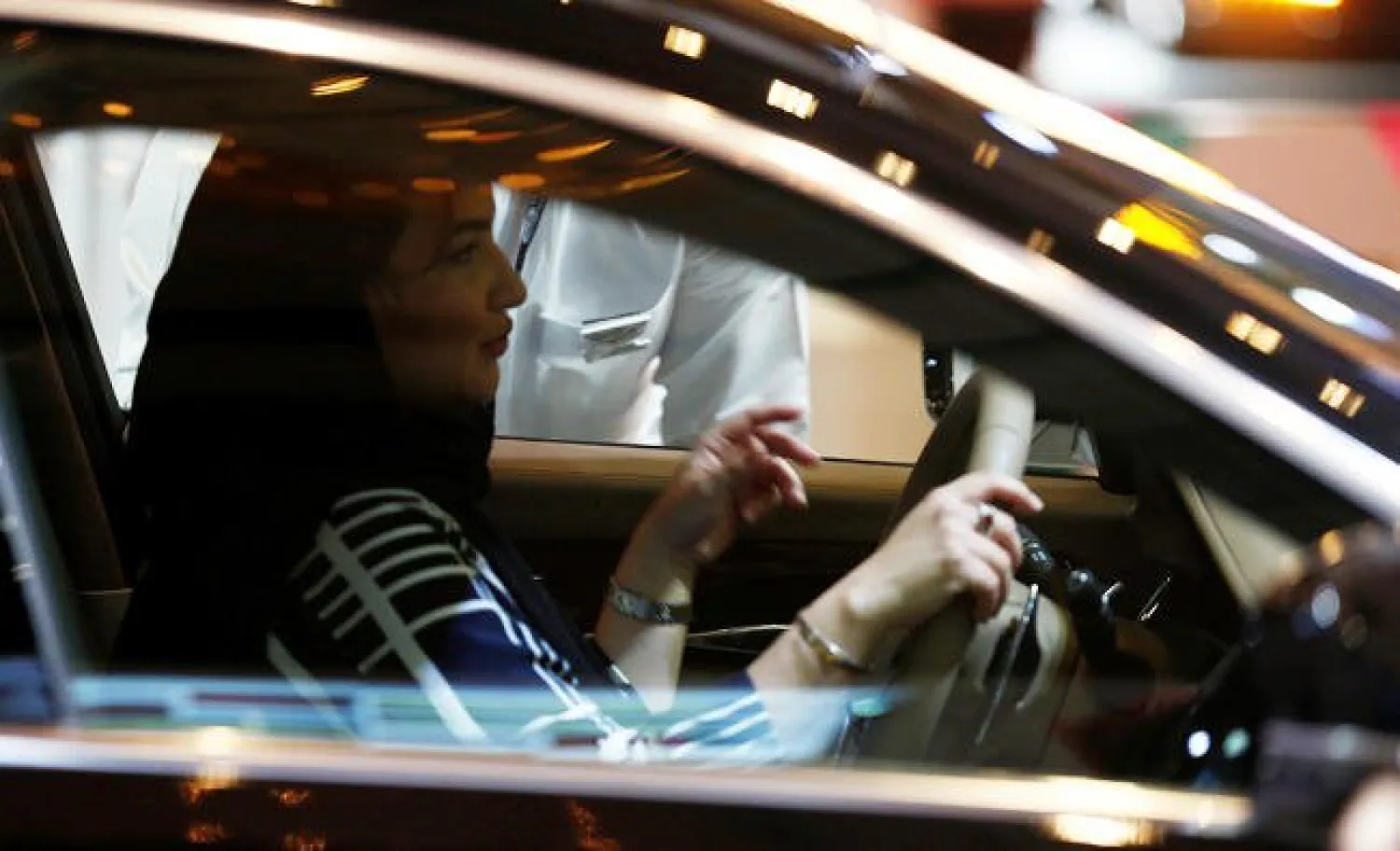 A Saudi woman checks a car at a showroom in Riyadh, Saudi Arabia, on October 5, 2017. Reuters