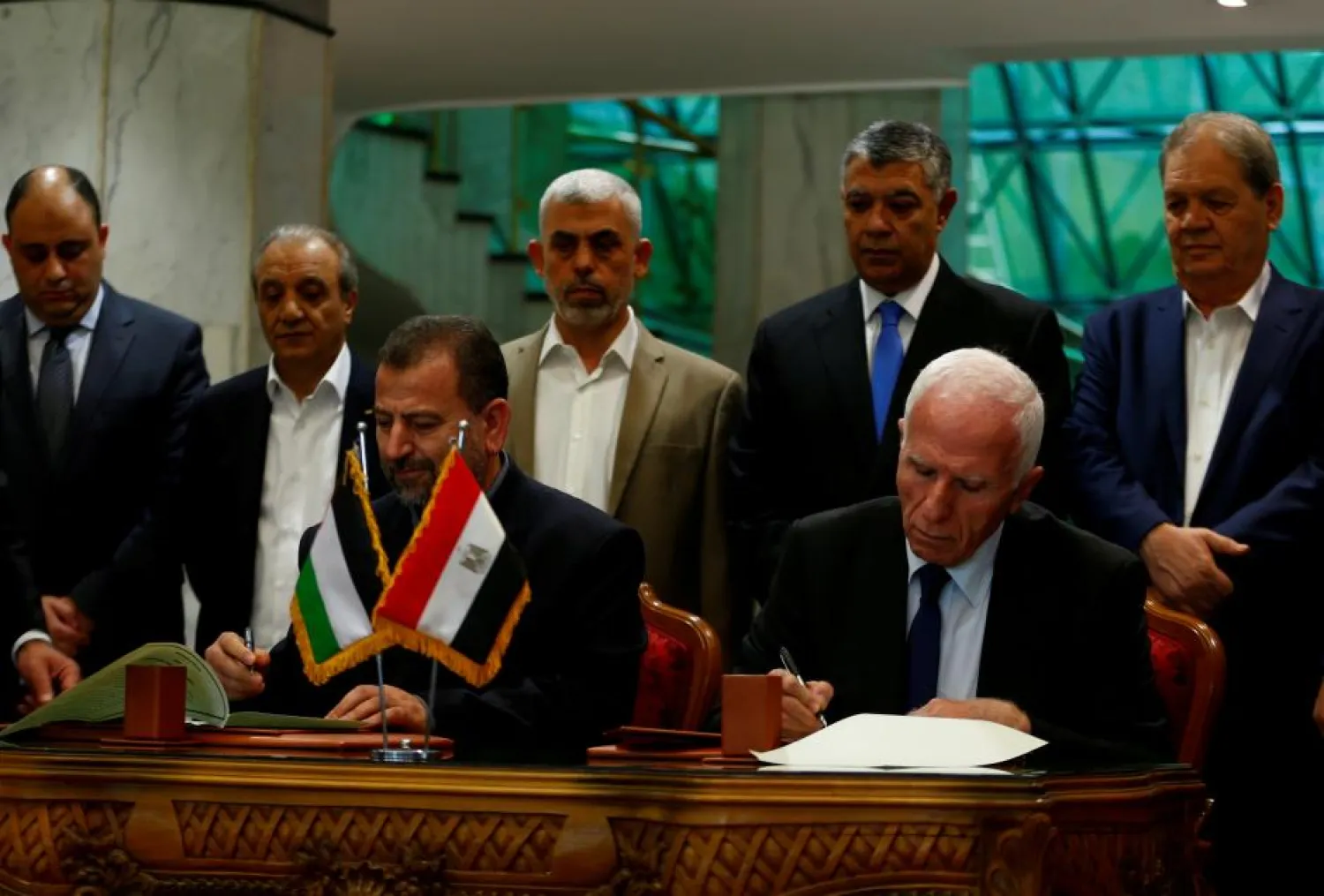 Head of Hamas delegation Saleh Arouri and Fatah leader Azzam Ahmad sign a reconciliation deal in Cairo, Egypt, October 12, 2017. REUTERS/Amr Abdallah Dalsh