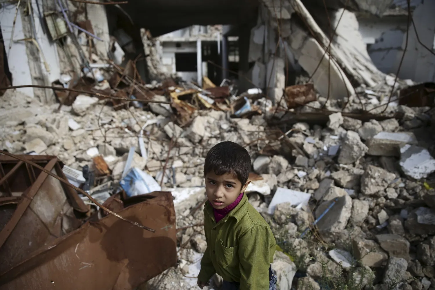 A boy walks amid damaged buildings in the town of Douma, Eastern Ghouta in Damascus, Syria. (Reuters)
