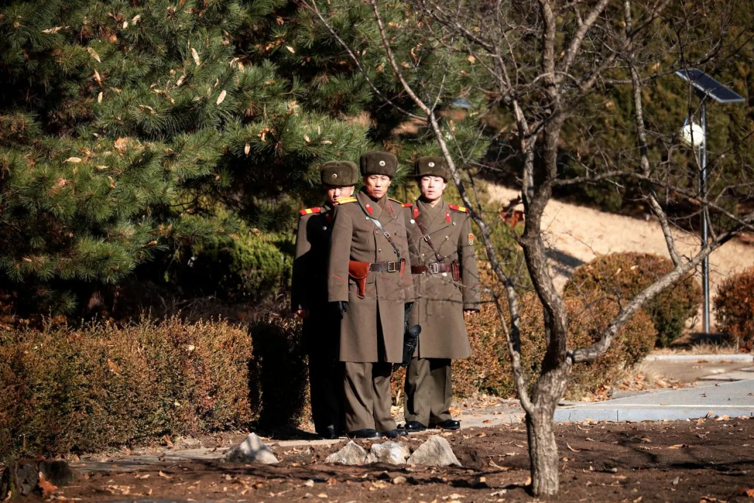 North Korean soldiers keep watch toward the south next to a spot where a North Korean defected crossing the border on November 13, at the truce village of Panmunjom, South Korea. (Reuters)