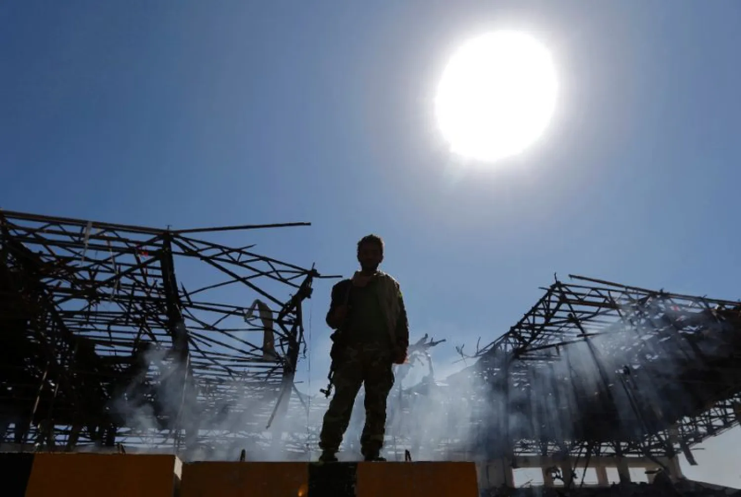 A Houthi fighter inspects the site of an air strike in the Yemeni capital Sanaa, on November 5, 2017 (AFP Photo/Mohammed HUWAIS)