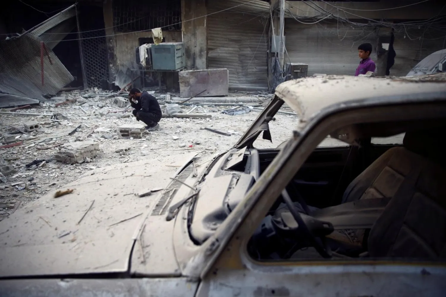 Syrian residents are seen reacting after shelling in Douma, in the eastern Damascus suburb of Ghouta, Syria November 17, 2017. REUTERS/Bassam Khabieh