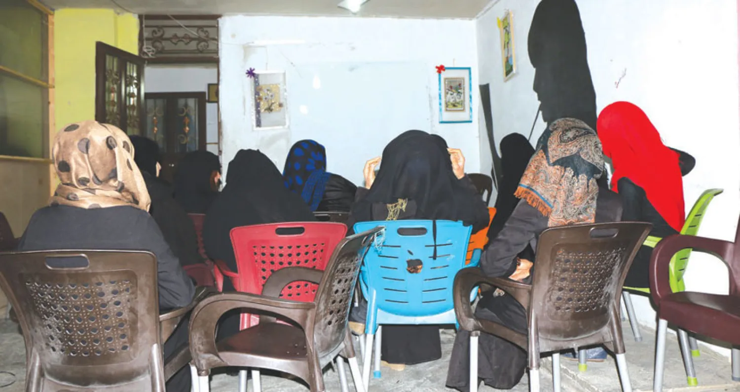 Widows attending a support group meeting at the National Defense Forces headquarters, Asharq Al-Awsat 
