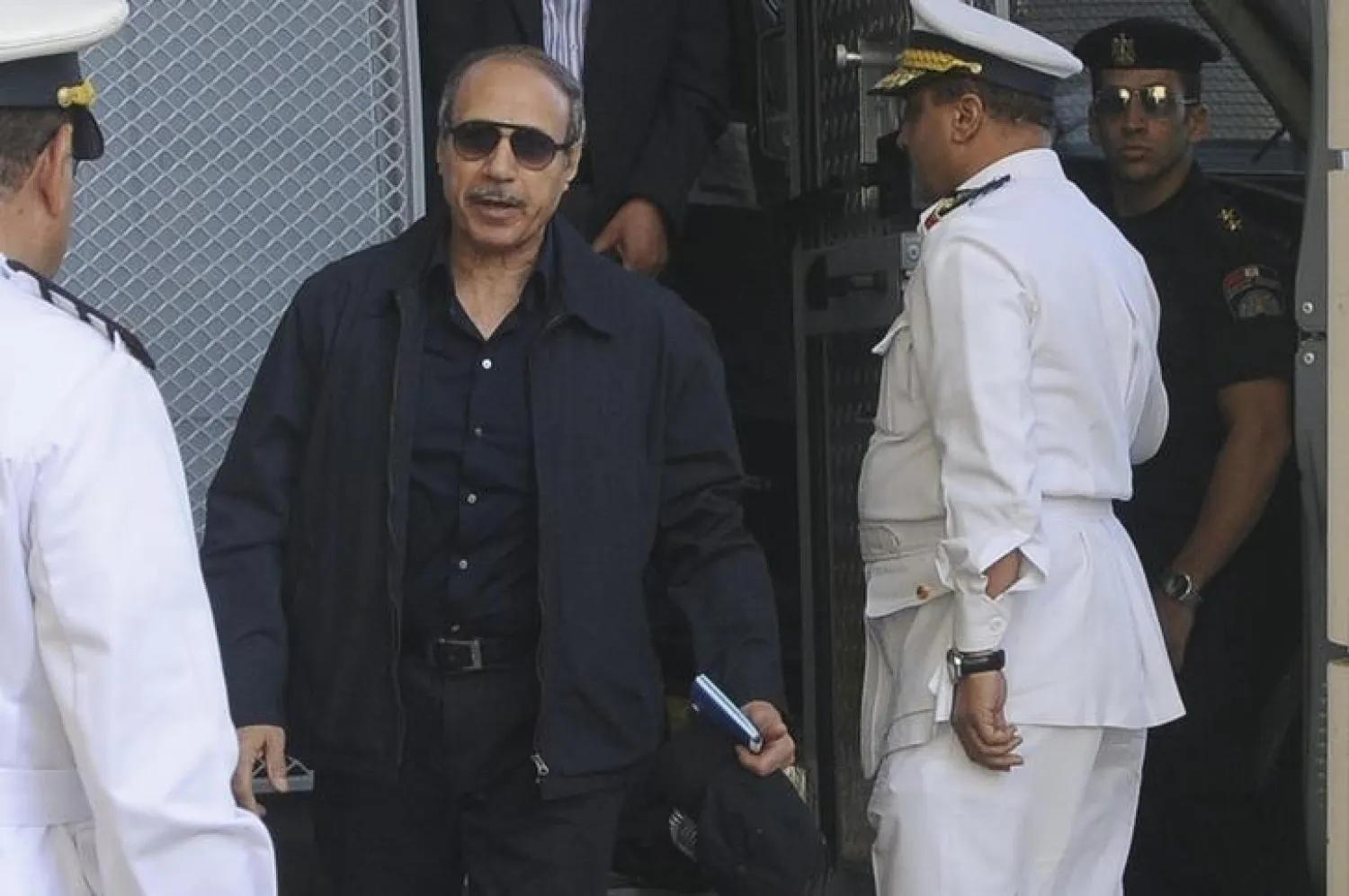 Egypt’s former Interior Minister Habib al-Adli (2nd L) walks after being sentenced in Cairo June 2, 2012. REUTERS/Stringer/Files
