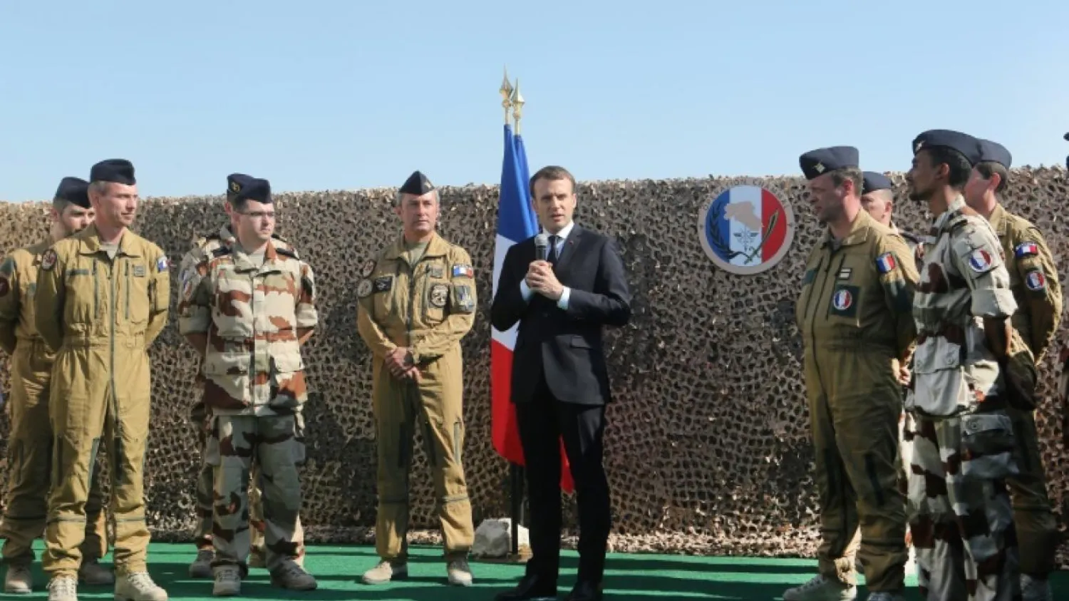 French President Emmanuel Macron delivers a speech to French officers stationed at the al-Udeid Air Base in Doha on December 7, 2017. KARIM JAAFAR / AFP