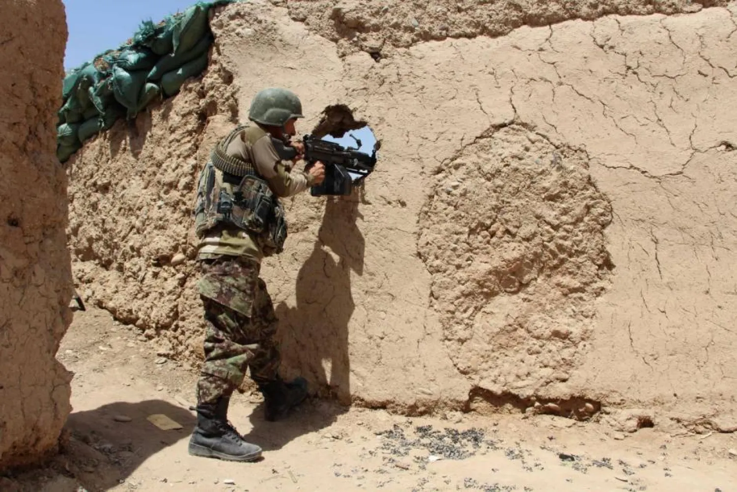 An Afghan National Army soldier mans his position at an outpost in Babaji area of Lashkar Gah Helmand province, Afghanistan May 8, 2016. (Reuters)
